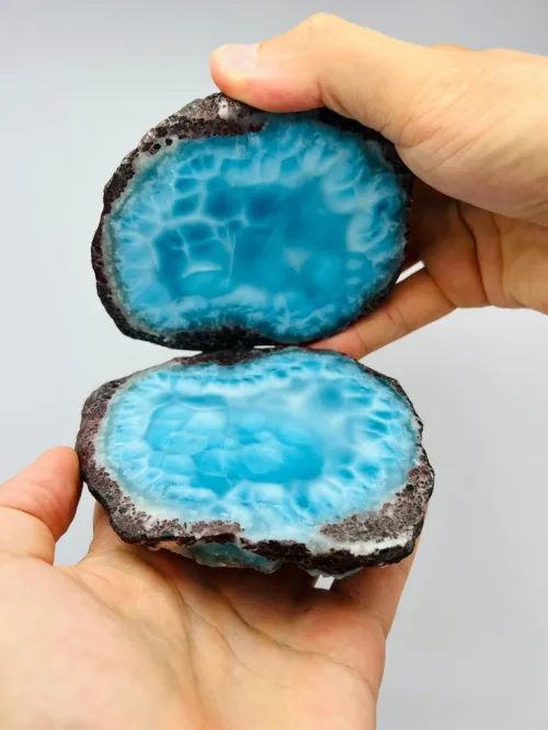 Blue kyanite crystals arranged around laptop and smartphone