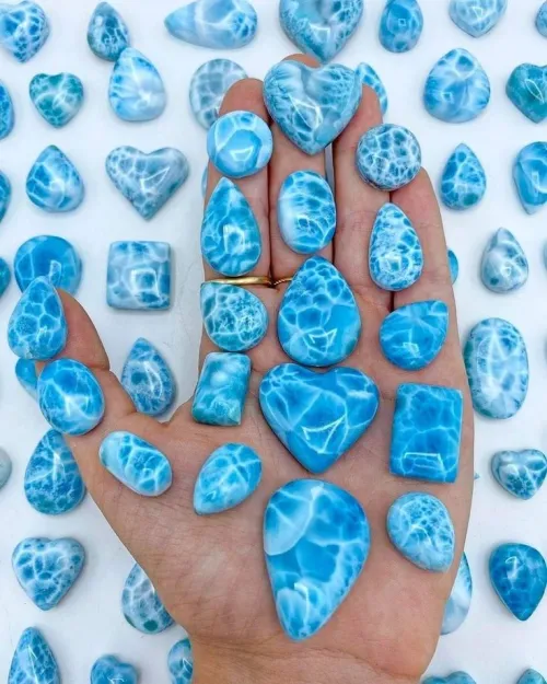 Polished blue Kyanite stone resting on textured rock surface